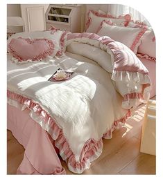 a bed with pink ruffled bedspread and pillows