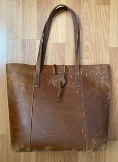 "Vintage Handmade Distressed Brown Leather Hobo Shoulder Bag Large Tote  Made in USA  Leather Strap Closure, Leather & Canvas Strap  Length 13\" x Width 5.5\" x Height 13\" Strap drop 10\" Condition is Used The exterior has some scuffs. The interior is in very good condition  This is a rare find. It has a beautiful rustic distressed leather look." Hobo Shoulder Bag, Distressed Leather, Leather Hobo, Large Tote, Large Bags, Purses And Handbags, Leather Straps, Brown Leather, Made In Usa