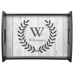 a personalized serving tray with a monogrammed wreath on the front and bottom