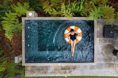 a woman floating on an inflatable raft in the middle of a swimming pool