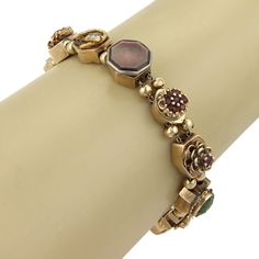 "This is a beautiful vintage retro gold bracelet, it is crafted from solid 14k yellow gold with a fine polished finish and boast thirteen slide charms in assorted size and shapes, all strung through a double chain bracelet, each charm is separated by two gold beads.  The charms are decorated with all color gemstones, such as: garnet, opal, jade, blue topaz, seed pearls, sapphire and mother of pearl. It fastens with a push in clasp. This slide bracelet is certainly a conversation piece, add it no Luxury Heirloom Bracelet With Vintage Charm, Luxury Vintage Bracelet With Gold Clasp, Double Chain Bracelet, Gold Slides, Slide Bracelet, Bracelet Box, Antique Bracelets, Garnet Bracelet, Bangles Jewelry Designs