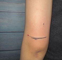 a woman's arm with a small tattoo on the left side of her arm