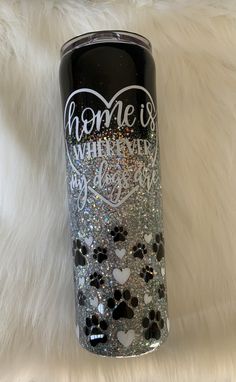 a black and silver glitter tumbler with hearts on it