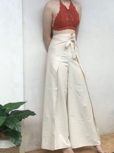 Bali Pants Outfit, Linen Wrap Pants, Wrap Trousers Outfit, Beach Harem Pants In Solid Cotton, Beach Cotton Harem Pants, Beach Cotton Harem Pants In Solid Color, Pants With Slits On The Side, High Waist Beige Cotton Harem Pants, Versatile Cotton Wide Leg Pants For Vacation