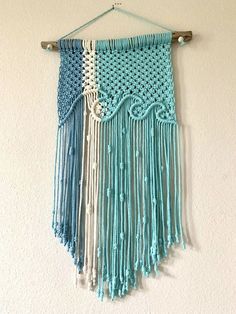 a blue and white crocheted wall hanging