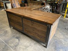 a large wooden table sitting inside of a garage