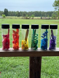 the four cups are filled with different colored candies