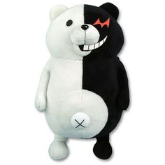 a black and white stuffed bear with fangs on it's face is standing upright