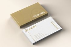 two business cards sitting on top of each other