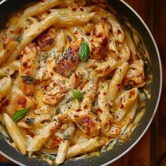 a pan filled with pasta covered in sauce and cheese