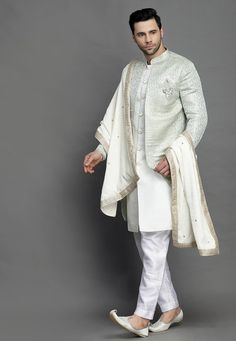 Art Brocade Silk and Art Silk Layered Sherwani in Light BeigeThis Readymade attire is Enhanced with Buttons. Crafted in Chinese Collar Neck and Full SleeveAvailable with an Art Silk Pant in Off WhiteDo note: Brooch, Dupatta and Footwear shown in the image is for presentation purposes only. Half to one inch may vary in measurement. (Slight variation in actual color vs. image is possible) We sell all kinds of menswear. Mens Kurta | Mens Kurta Pajama | Mens Sherwani | Mens Sherwani Sets | Tradition Pista Green Kurta For Reception With Traditional Drape, Pista Green Kurta With Traditional Drape For Reception, Ceremonial Pista Green Kurta With Traditional Drape, Pista Green Sherwani With Dupatta For Diwali, Festive Pista Green Sherwani With Dupatta, Eid Nehru Jacket With Dupatta For Reception, Pista Green Sherwani With Dupatta For Eid, Long Bandhgala With Dupatta For Festivals, Festive Pista Green Bandhgala With Dupatta