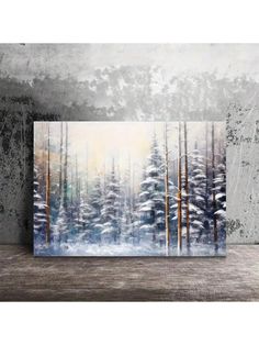 a painting on a wall with trees and snow in the foreground, against a concrete background