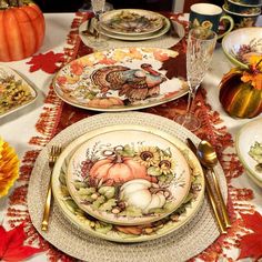 a table set for thanksgiving dinner with plates and silverware