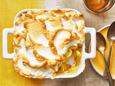 a casserole dish filled with food on top of a yellow and white table cloth