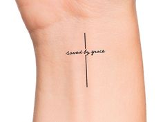 a woman's wrist with the words saved by grace written on her left arm