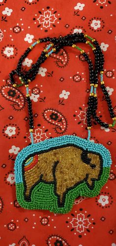 a beaded necklace with an animal on it