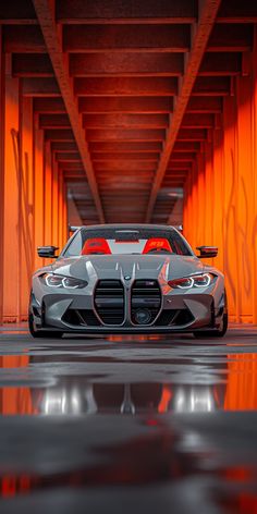 a gray sports car parked in an orange tunnel