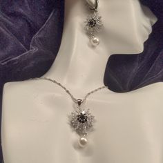 Beautiful Black And Clear Cz Pierced Earrings, With Faux Pearl Drop, 17" Necklace With 2" Extender, Black And Clear Czs With Faux Pearl Drop, And Size 7 Black And Clear Cz Ring. All Flowers Are 3/4" Across, Earrings Have 2" Overall Length And Necklace Has 1 3/4" Length From Chain. I Even Included A Picture Of This Nana's Wrinkly Old Hand With The Ring On So You Can Estimate How Much Better It Will Look On You! Seriously This Looks Very Expensive, Ring Is Marked '925'. Elegant Black Metal Jewelry Sets, Glamorous Black Jewelry With Sparkling Stones, Black Jewelry With Sparkling Stones For Wedding, Black Cubic Zirconia Jewelry With Sparkling Stones, Black Sparkling Stones Jewelry For Wedding, Elegant Jewelry With Flower Pendant And Matching Earrings, Silver Flower Shaped Jewelry Sets For Formal Occasions, Silver Sterling Silver Jewelry Sets For Evening, Black Sparkling Stones Wedding Jewelry