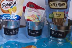 three buckets filled with candy sitting on top of a table