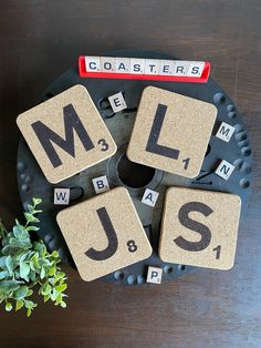 scrabbled coasters with letters spelling out the word mll