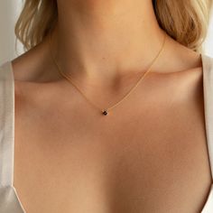 O N Y X ∙ D A I N T Y ∙ D I A M O N D ∙ N E C K L A C E The Onyx Dainty Diamond Necklace is our take on a vintage inspired classic. With a simple round black stone on a delicate chain, it is versatile enough for a modern minimal look, or mix things up by adding an essence of gothic glam to your outfit. * Material: High Quality Solid 925 Sterling Silver * Finish: Sterling Silver ∙ 18K Gold * Featuring a 4mm Round Black CZ Diamond Charm with adjustable chain 16 inches to 18 inches. H O W ∙ T O ∙ O Gothic Glam, Black Stone Ring, Dainty Diamond Necklace, Diamond Solitaire Necklace, Solitaire Necklaces, Diamond Charm, Delicate Chain, Love Charms, Elegant Necklaces