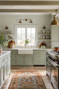 a kitchen with green cabinets and an area rug