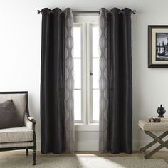 a living room with white walls and black curtains