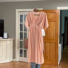 Exquisite Elegant Peach Daywear Dress, Elegant Peach Dress For Daywear, Knee-length Dress With Side Slits For Brunch, Chic Peach V-neck Dress, Midi Dress With Side Slits For Brunch, Open Front Dresses For Daywear, Peach Midi Dress For Day Out, Elegant Peach V-neck Maxi Dress, Peach V-neck Evening Dress