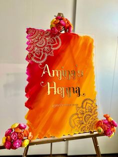 an orange and red sign with flowers on it that says amarya's hema