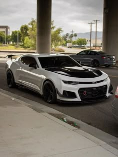 the chevrolet camaro is parked on the side of the road