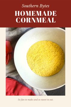 a white bowl filled with yellow cornmeal on top of a table