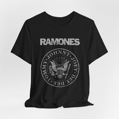 RAMONES Logo T-shirt Shirt Tshirt Band Tee Vintage Aesthetic Distressed  This classic unisex jersey short sleeve tee fits like a well-loved favorite. Soft cotton and quality print make users fall in love with it over and over again. These t-shirts have-ribbed knit collars to bolster shaping. The shoulders have taping for better fit over time. Dual side seams hold the garment's shape for longer.  .: 100% Airlume combed and ringspun cotton (fiber content may vary for different colors) .: Light fabric (4.2 oz/yd² (142 g/m .: Retail fit .: Tear away label .: Runs true to size Grunge Crew Neck T-shirt With Letter Print, Grunge Short Sleeve T-shirt With Text Print, Grunge Short Sleeve T-shirt For Concert, Alternative Style Graphic T-shirt With Short Sleeves, Graphic Tee With Band Logo And Crew Neck, Band Logo Graphic Tee With Crew Neck, Relaxed Fit Band Merch T-shirt With Logo, Grunge T-shirt With Letter Print And Crew Neck, Band Merch T-shirt With Band Logo, Short Sleeve