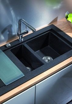 a black sink sitting on top of a wooden counter