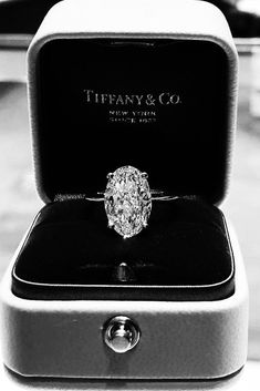 a diamond ring sitting in a box on top of a table