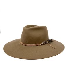 Remaining true to our classic shapes but with a twist! The montana fedora is made from a lite stockman felt and has a slightly rounder crown and has a stiff and sturdy feel . Trimmed with deer skin leather and feather, she will be your new fall fave! Add "custom embroidery" to make it more personal. Made in the U.S.A small 21-22 inches medium 22-23 inches large 23-24 inches Fall Faves, Felt Fedora, Deer Skin, Custom Embroidery, We Wear, Fedora, Montana, Deer, Felt