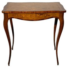 a small wooden table with an intricate design on it's top and bottom edge