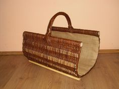 a brown wicker bag sitting on top of a wooden floor next to a wall