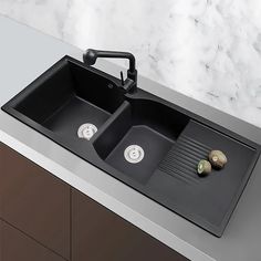 two black sinks sitting on top of a counter