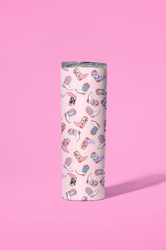 a white tumbler cup with pink and blue designs on the side against a pink background