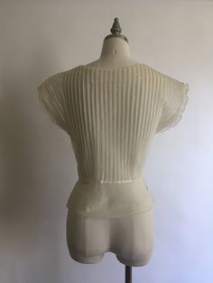 "Gorgeous sheer 1940's short sleeve nylon blouse with lace collar and rhinestones has pretty cap sleeves with a layer of pleated ruffle. Blouse zips up on the side and is in excellent vintage condition. Made by Debcraft and possibly one of the nicest nylon blouses I have come across! Shoulders 15\" Chest up to 36\" Waist 28\" Length from back of neck to hem 18\" Vintage garments have been previously worn and lovingly cared for, they may however have a blemish or two. Here at MadelonVintage, I tr Retro Fitted Short Sleeve Blouse, Fitted Retro Cream Top, Elegant Fitted Tops With Cap Sleeves, Fitted Short Sleeve Evening Blouse, Classic Short Sleeve Tops For Wedding, Fitted Short Sleeve Blouse For Wedding, Fitted Vintage White Top, Fitted Vintage White Blouse For Daywear, Fitted Vintage White Top For Daywear