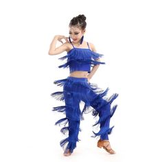 a woman in blue is dancing with her hands on her hips and one leg behind her head