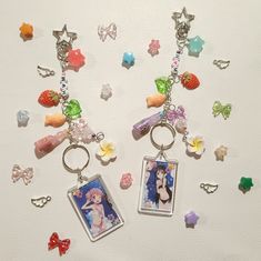 two key chains with pictures and charms attached to them