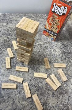 a stack of wooden dominos sitting on top of a counter next to a box of jeriga