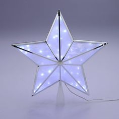 a white star shaped light up decoration with lights on the bottom and sides, sitting in front of a gray background