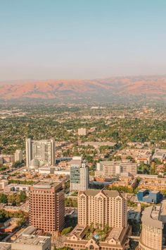 an aerial view of the city with mountains in the background