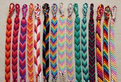 several different colored braids are lined up on a table with one knot in the middle