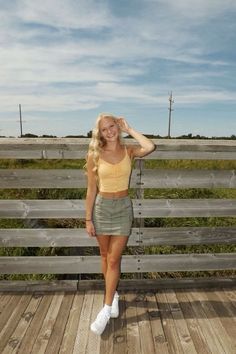 a woman standing on top of a wooden deck