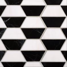 a black and white tiled wall with hexagonal shapes