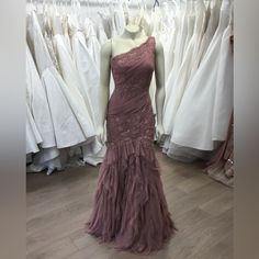 a mannequin in front of dresses on display