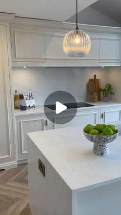 a bowl of fruit sitting on top of a kitchen counter